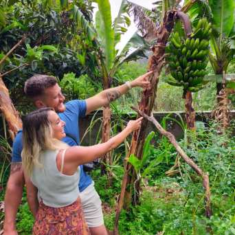 a young girl standing next to a tree