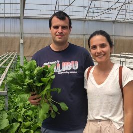 a smiling man and woman posing for a picture