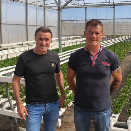 a man standing in front of a group of people posing for the camera