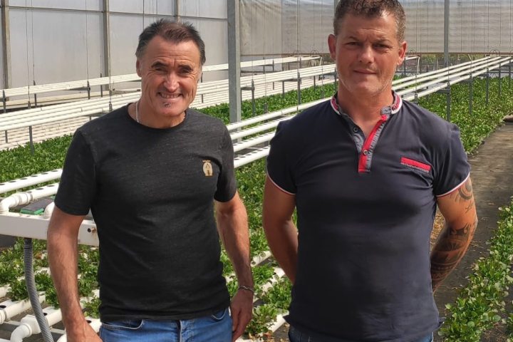 a man standing in front of a group of people posing for the camera