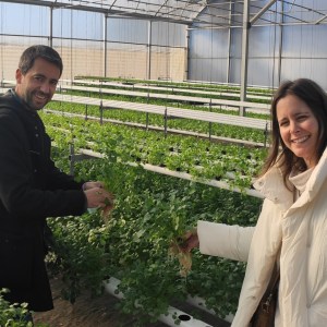 a woman standing next to a fence