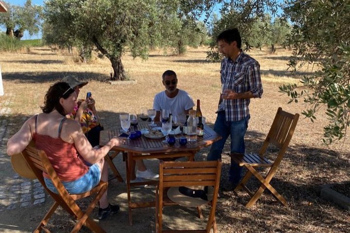 a group of people sitting on a bench in a park