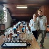 a group of people standing around a table with wine glasses