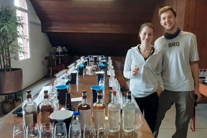 a group of people standing around a table with wine glasses