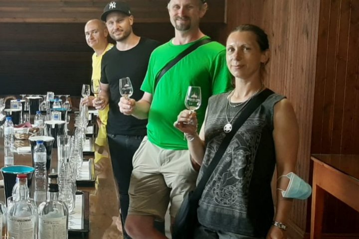 a group of people standing around a table