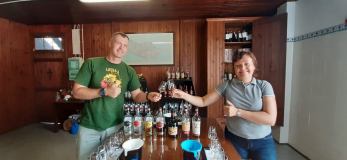 a person standing next to a bottle of wine