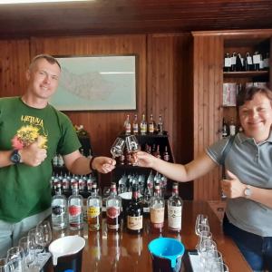 a person standing next to a bottle of wine