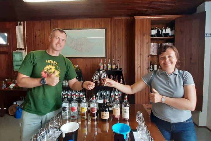 a person standing next to a bottle of wine