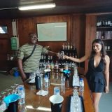 a group of people standing around a table with wine glasses