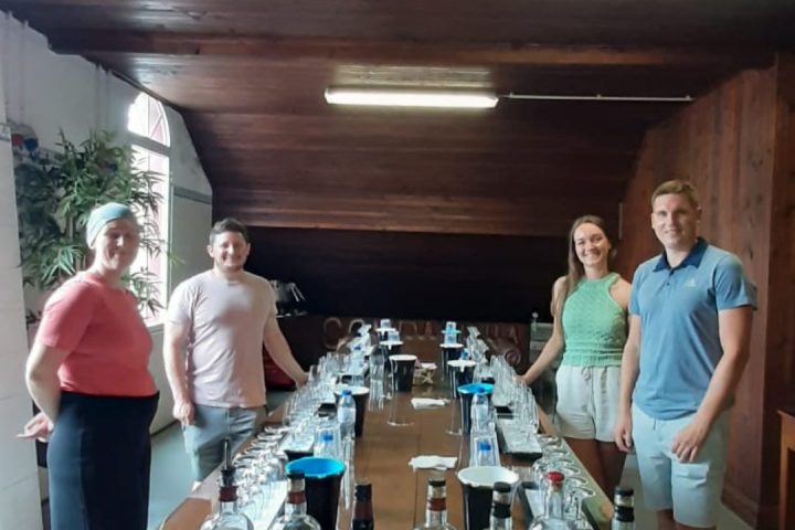 a group of people standing around a table