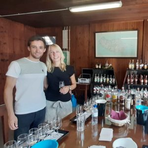 Hugh Jackman et al. sitting at a table with wine glasses