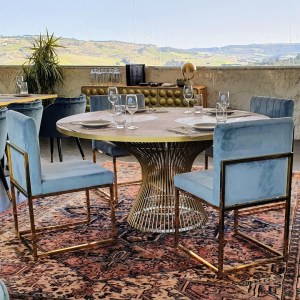 a group of people sitting at a table with a blue chair