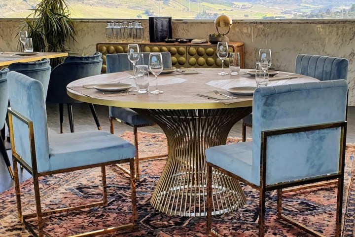 a group of people sitting at a table with a blue chair