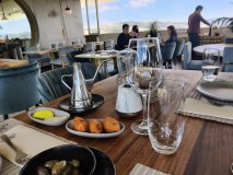 a group of people sitting at a table with a plate of food