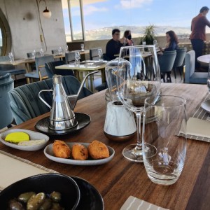 a group of people sitting at a table with a plate of food