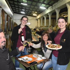 a group of people sitting at a table eating food