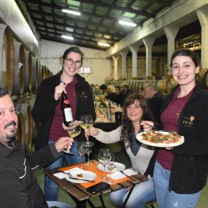 a group of people sitting at a table eating food