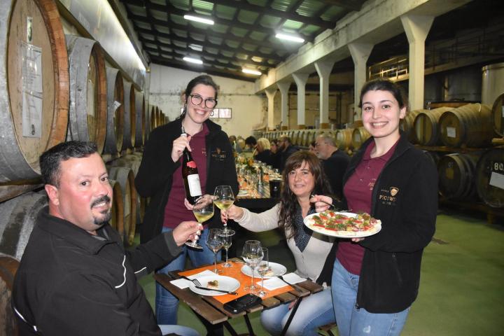 a group of people sitting at a table eating food