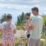 a group of people looking at a cell phone