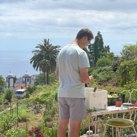a man standing in front of a tree