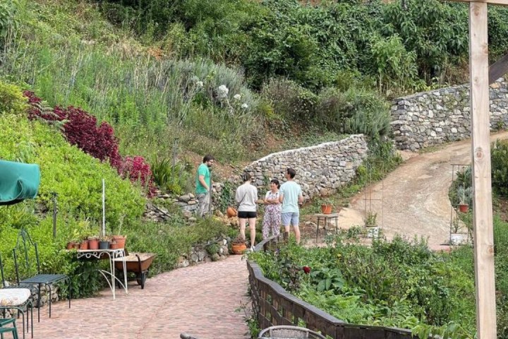 a person sitting on a bench next to a fence