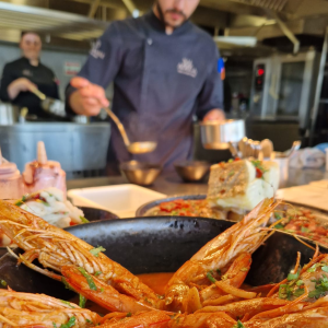 a group of people preparing food in a kitchen