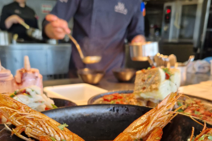 a group of people preparing food in a kitchen
