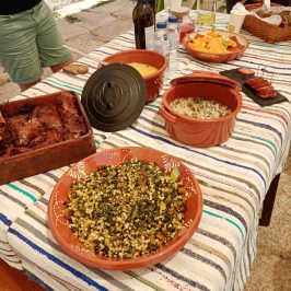 a woman sitting at a table with a plate of food