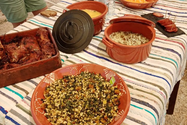 a woman sitting at a table with a plate of food