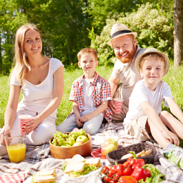 a group of people sitting at a picnic table