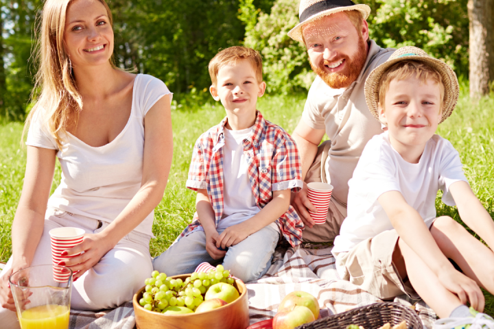 a group of people sitting at a picnic table