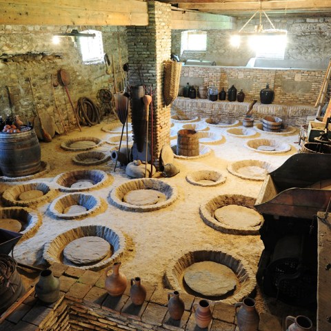 a group of people sitting at a table in front of a building