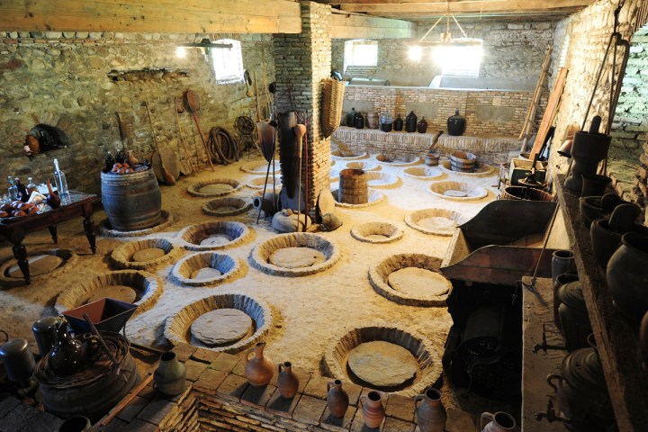 a group of people sitting at a table in front of a building