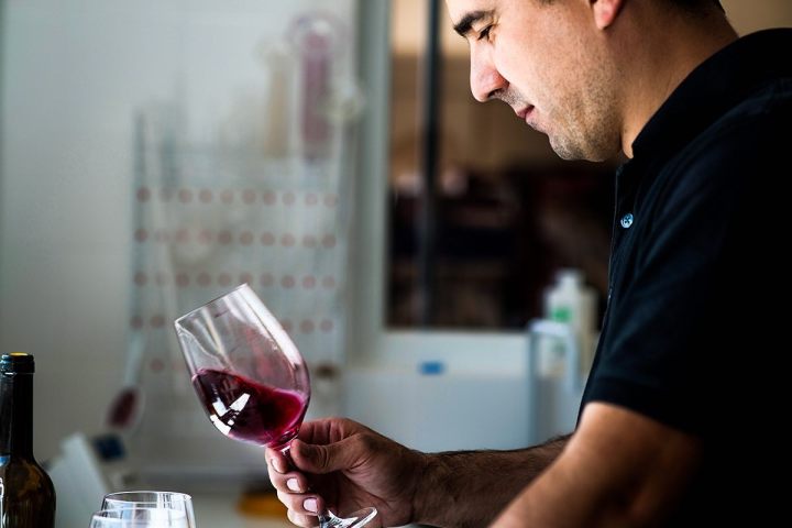 a man holding a glass of wine