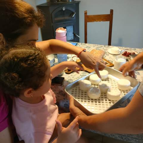 Child and adult making Viseu Goat Cheese Making tour