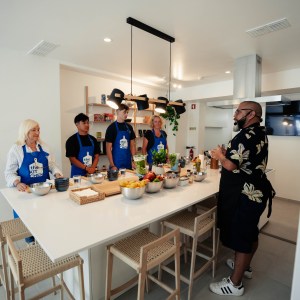 a group of people standing in a kitchen