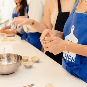 a woman sitting at a table with food