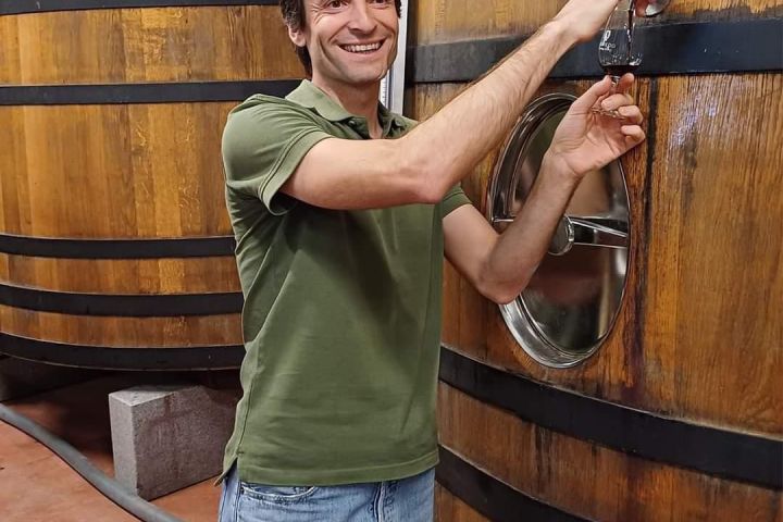 a person standing in front of a barrel