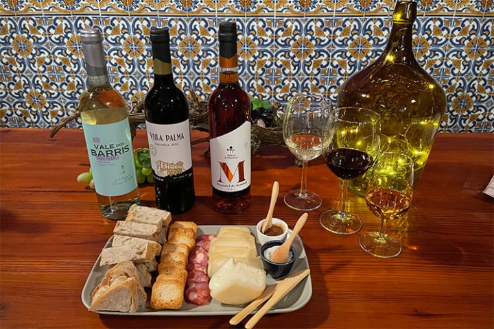 a bottle of wine sitting on top of a wooden table