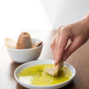 a person holding a bowl of food on a table