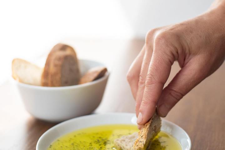 a person holding a bowl of food on a table