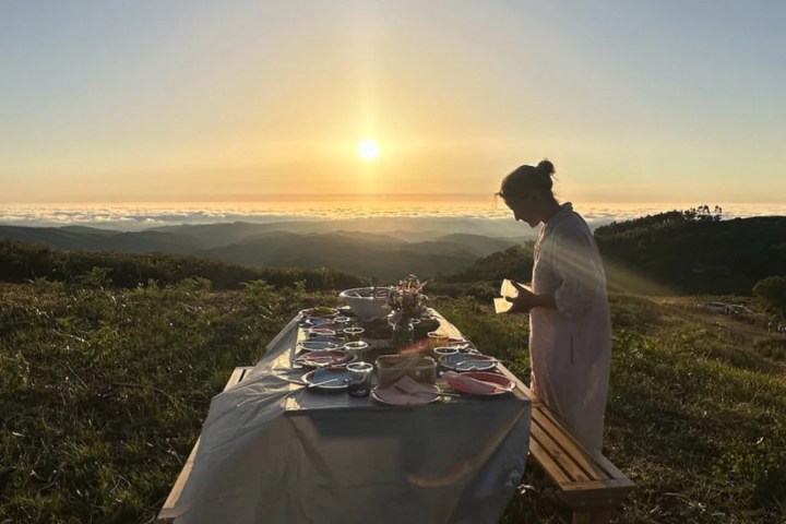Couple enjoying a private sunset picnic in Monchique mountains overlooking the Atlantic