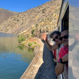 Douro Valley train travelling along the river through terraced vineyards between Pinhão and Pocinho