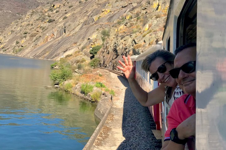 Douro Valley train travelling along the river through terraced vineyards between Pinhão and Pocinho