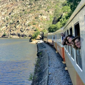 Douro Valley scenic train journey along the riverbank between Pinhão and Régua at dusk