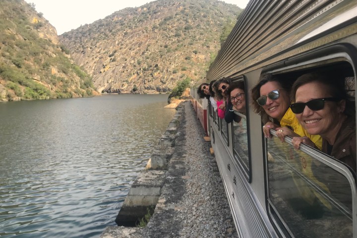 Douro Valley scenic train journey along the riverbank between Pinhão and Régua at dusk