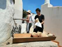 Shaping bread dough by hand before baking in a wood-fired oven