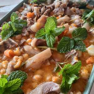 Traditional açorda dish served with herbs at an Algarve farm lunch