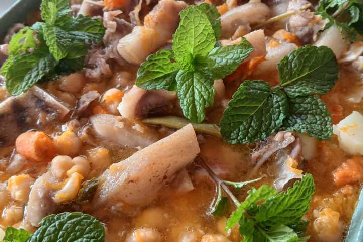Traditional açorda dish served with herbs at an Algarve farm lunch