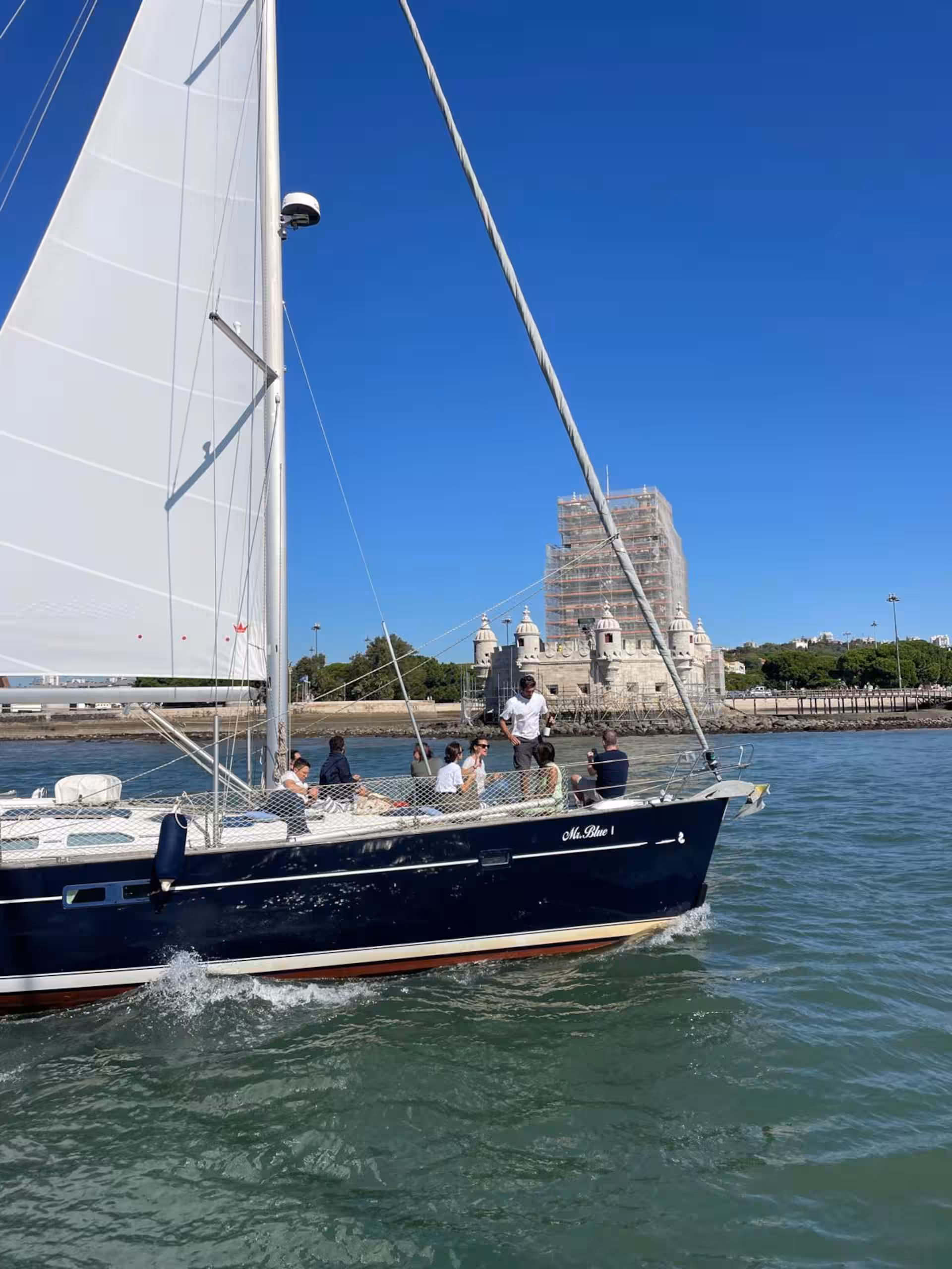 View of Cristo Rei and Ponte 25 de Abril from a private sailboat on the Tagus River in Lisbon
